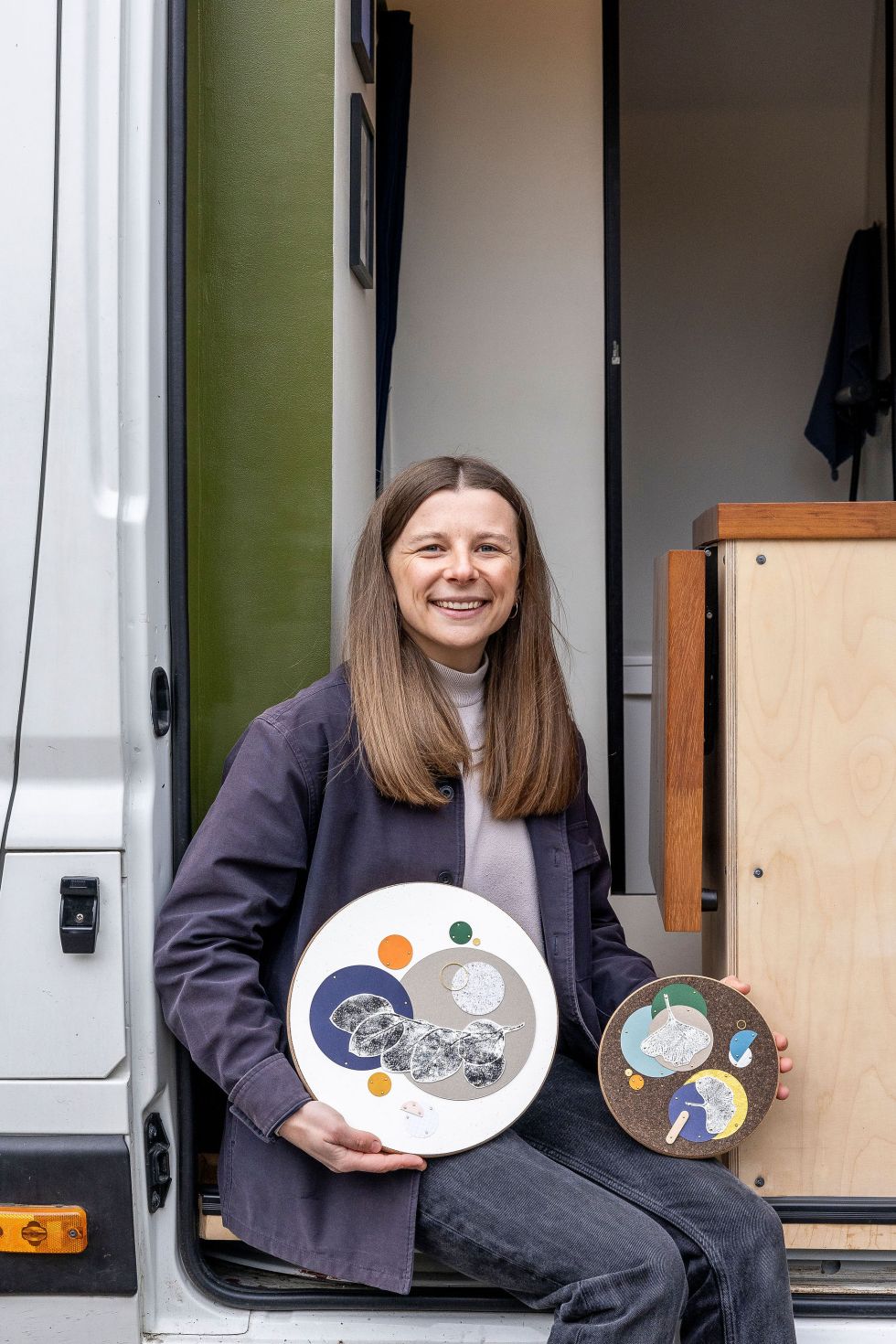 Amy Quinn displaying her art in her van studio. Image by Christina Davies, Fish2Photos