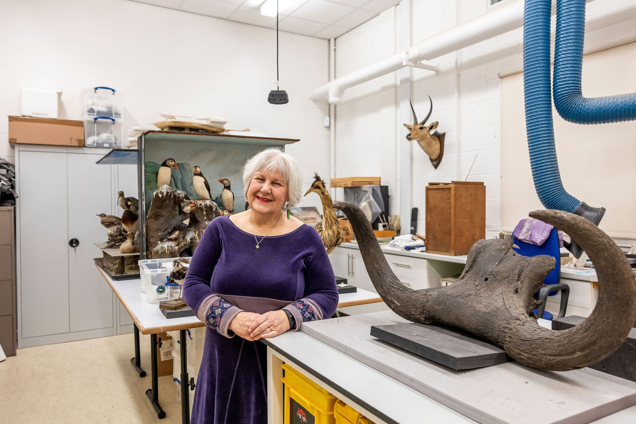 Julie Posing with an artefact at the Conservation Studio. Image by Christina Davies, Fish2Photo